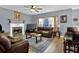 Relaxing living room with leather furniture, fireplace, and hardwood floors at 1035 Bridle Path Dr, Lawrenceville, GA 30045