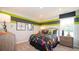 Fun bedroom with a splash design comforter and bright accent paint at 146 Oakchase Park Ln, Hampton, GA 30228