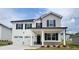 Charming two-story home with a two-car garage, covered porch, and landscaped front yard offers an inviting curb appeal at 146 Oakchase Park Ln, Hampton, GA 30228