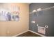Simple laundry room with gray accent wall and dark faux wood flooring at 146 Oakchase Park Ln, Hampton, GA 30228