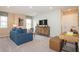 Spacious living room with a large TV, comfortable couch, and modern decor perfect for entertainment and relaxation at 146 Oakchase Park Ln, Hampton, GA 30228