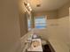 Clean bathroom, white tub and vanity, updated flooring at 2028 Wells Sw Dr, Atlanta, GA 30311