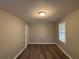 Simple bedroom with hardwood floors and a window at 2028 Wells Sw Dr, Atlanta, GA 30311