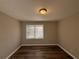 Spacious bedroom featuring wood-look floors and a large window at 2028 Wells Sw Dr, Atlanta, GA 30311