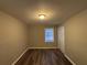 Charming bedroom with wood-look floors and a window with blinds at 2028 Wells Sw Dr, Atlanta, GA 30311