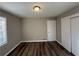 Well-lit bedroom with wood-look floors and a door to hallway at 2028 Wells Sw Dr, Atlanta, GA 30311