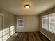 Sunny bedroom with wood-look floors and two windows at 2028 Wells Sw Dr, Atlanta, GA 30311