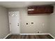 Laundry room with built-in cabinets and vinyl flooring at 2028 Wells Sw Dr, Atlanta, GA 30311