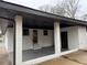 Renovated back patio with covered area, storage shed and gray concrete flooring at 2662 Sweetwater St, Austell, GA 30106