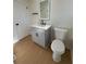 Modern bathroom with gray vanity, quartz countertop, and lighted mirror at 2662 Sweetwater St, Austell, GA 30106