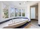 Luxurious bathroom with soaking tub, walk-in shower, and large windows at 2853 N Hills Ne Dr, Atlanta, GA 30305