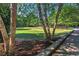 Landscaped green space with mature trees and stone wall at 2853 N Hills Ne Dr, Atlanta, GA 30305