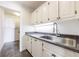 Laundry room with utility sink and ample cabinet storage at 2853 N Hills Ne Dr, Atlanta, GA 30305