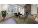 Living room with stone fireplace, hardwood floors and large windows at 2853 N Hills Ne Dr, Atlanta, GA 30305