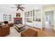 Spacious living room featuring a fireplace, built-in shelving, and hardwood floors at 2853 N Hills Ne Dr, Atlanta, GA 30305