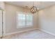 Bedroom with neutral carpet, plantation shutters, and a modern light fixture at 324 Concord St, Alpharetta, GA 30009