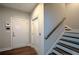 Hallway featuring garage access and staircase with hardwood treads and white risers at 324 Concord St, Alpharetta, GA 30009