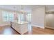 Well-lit kitchen featuring a large island with a sink, stainless steel appliances, and hardwood floors at 324 Concord St, Alpharetta, GA 30009