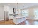 Bright kitchen featuring stainless steel appliances, hardwood floors, and a large center island at 324 Concord St, Alpharetta, GA 30009