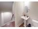 Powder room featuring a pedestal sink, modern fixtures, and convenient access to the stairs at 324 Concord St, Alpharetta, GA 30009