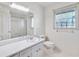 Bathroom with single vanity, shower, and window at 1892 Mercedes Ne Ct, Atlanta, GA 30345