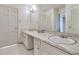 Clean bathroom with double vanity and large mirror at 1892 Mercedes Ne Ct, Atlanta, GA 30345