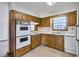 Kitchen with wood cabinets, double oven and flooring at 1892 Mercedes Ne Ct, Atlanta, GA 30345