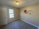 Bedroom with carpet, window, and decorative wall art at 3959 Wood Path Dr, Stone Mountain, GA 30083