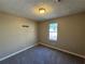 Simple bedroom with carpet, window, and neutral walls at 3959 Wood Path Dr, Stone Mountain, GA 30083