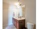 Powder room with ample lighting, granite counters, and tiled floor at 200 Claret Way, Mcdonough, GA 30252