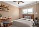 This staged bedroom features a neutral color scheme and natural light from the window at 200 Claret Way, Mcdonough, GA 30252