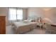 Cozy bedroom with natural light, neutral colors, and comfortable furnishings at 200 Claret Way, Mcdonough, GA 30252