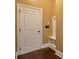 Hallway with an entryway area, wood floors, and white door at 200 Claret Way, Mcdonough, GA 30252