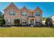 Charming brick two-story home with a well-maintained lawn and mature landscaping at 200 Claret Way, Mcdonough, GA 30252