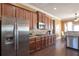 Modern kitchen with stainless steel appliances, dark wood cabinets, and granite countertops at 200 Claret Way, Mcdonough, GA 30252