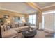 Comfortable living room with a plush sectional sofa, natural light, and neutral decor at 200 Claret Way, Mcdonough, GA 30252