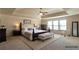 Bright main bedroom features tray ceilings, neutral tones, and an area rug at 200 Claret Way, Mcdonough, GA 30252