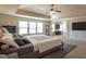 Spacious main bedroom with tray ceiling, sitting area, TV, and plenty of natural light at 200 Claret Way, Mcdonough, GA 30252