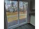 A sliding glass door opens onto a deck with a view of a green, wooded backyard at 2755 Berry Rd, Loganville, GA 30052
