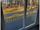 A sliding glass door opens onto a deck with a view of a green, wooded backyard at 2755 Berry Rd, Loganville, GA 30052