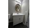 Bathroom featuring vanity with oval mirror and white cabinets at 2755 Berry Rd, Loganville, GA 30052