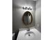 Bathroom featuring vanity with oval mirror, sink, and white cabinets at 2755 Berry Rd, Loganville, GA 30052