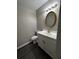 Bathroom featuring vanity with oval mirror, sink, and white cabinets at 2755 Berry Rd, Loganville, GA 30052