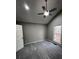 Bright bedroom featuring a ceiling fan, window with view of the backyard and plush carpeting at 2755 Berry Rd, Loganville, GA 30052