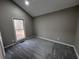 Comfortable bedroom featuring neutral paint, plush carpeting, and a window overlooking the backyard at 2755 Berry Rd, Loganville, GA 30052