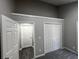 Neutral bedroom with gray walls, white trim, and carpeted floors, featuring closet and doorway at 2755 Berry Rd, Loganville, GA 30052