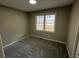 Carpeted bedroom with large window at 2755 Berry Rd, Loganville, GA 30052