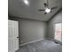 Bright bedroom featuring a ceiling fan, window with view of the backyard and plush carpeting at 2755 Berry Rd, Loganville, GA 30052