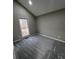 Comfortable bedroom featuring neutral paint, plush carpeting, and a window overlooking the backyard at 2755 Berry Rd, Loganville, GA 30052