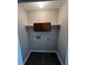 Functional laundry room with basic amenities and storage including dark wood floors and neutral wall color at 2755 Berry Rd, Loganville, GA 30052